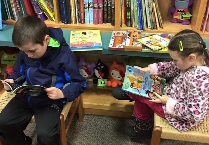 Annie working with students in a warm classroom setting